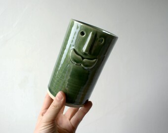 Versatile home decor ceramic vase with moustache face design glazed in green