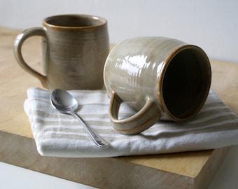 Set of two cozy stoneware pottery tea mugs glazed in glossy grey