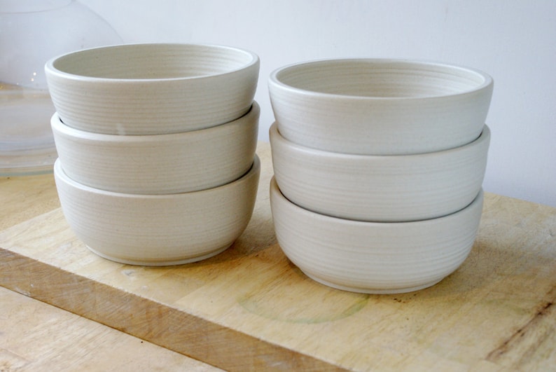 A set of six large salad bowls glazed in matt vanilla cream