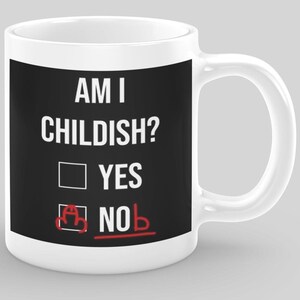 May include: White ceramic mug with a black panel displaying the question "AM I CHILDISH?" in white text. The "NO" option is marked with a red line and a doodle. A humorous gift idea.