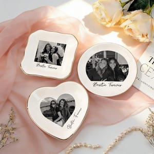 May include: Three white ceramic trinket dishes with gold-painted rims, each featuring a black and white photograph of two people and the text Bestie Forever. The dishes are square, round, and heart-shaped, displaying personalized memories.