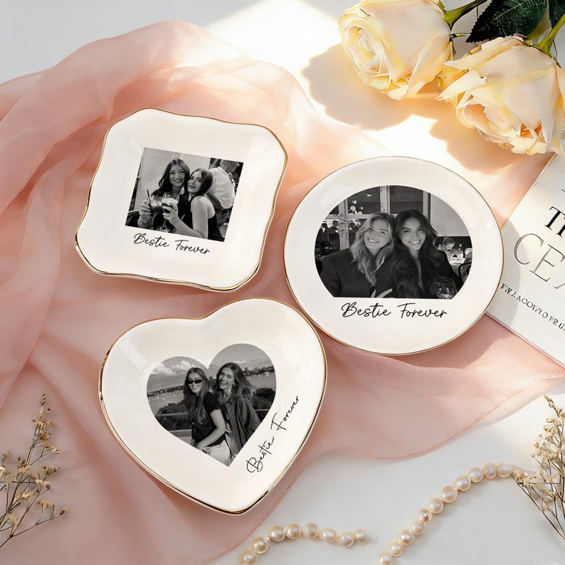 May include: Three white ceramic trinket dishes with gold-painted rims, each featuring a black and white photograph of two people and the text Bestie Forever. The dishes are square, round, and heart-shaped, displaying personalized memories.
