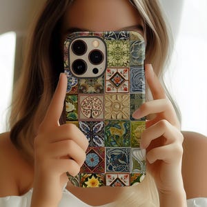 May include: A colorful phone case with a mosaic design featuring various patterns and colors, including green, blue, yellow, and brown. The case is made of durable plastic and fits snugly around the phone.