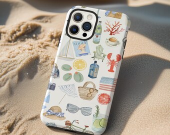 May include: White phone case with a nautical-themed pattern. The design includes illustrations of a sailboat, lobster, sunglasses, a straw hat, and a vintage Vogue magazine cover. The case is on a sandy surface.