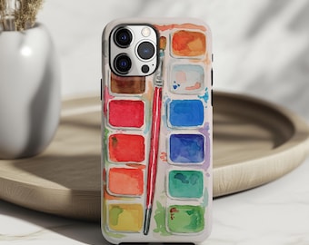 Puede incluir: Una funda de teléfono blanca con un diseño de acuarela de una paleta de pintura y un pincel. La paleta incluye varios colores como rojo, naranja, azul y verde. La funda tiene un acabado brillante y está diseñada para un smartphone.