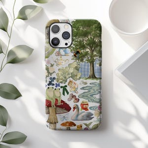 May include: A phone case featuring a whimsical collage of illustrations. The design includes a tree, a swan, mushrooms, frogs, and a teapot. The color palette is soft, with greens, blues, and browns. The case is designed to fit a smartphone.