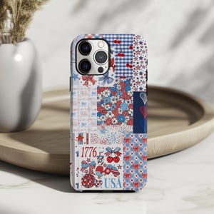May include: A smartphone case featuring a patriotic patchwork design in red, white, and blue. The pattern includes gingham, floral prints, cherries, bows, fireworks, and the text 1776 and USA. The layout incorporates stars, hearts, and popsicles.