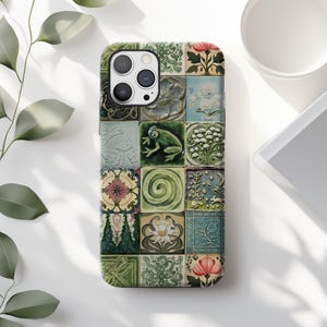 May include: A phone case with a colorful mosaic design featuring a green frog, flowers, and geometric patterns. The case is made of durable plastic and has a clear back to show off the phone's design.