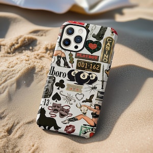 May include: A white iPhone case with a collage of tattoo-style graphics. The design includes a Playboy logo, a license plate, playing cards, a black cat, and a pin-up girl. The case has a red border.