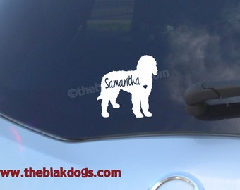 May include: White vinyl decal of a dog silhouette with the name Samantha and a small heart. The decal is on a blue car window.