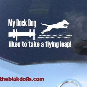 May include: White vinyl decal with the text "My Dock Dog likes to take a flying leap!" and a silhouette of a dog jumping over a dock. The text "www.theblakdogs.com" is at the bottom of the decal.