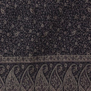 May include: Black shawl with a paisley pattern and a border of smaller paisley designs.