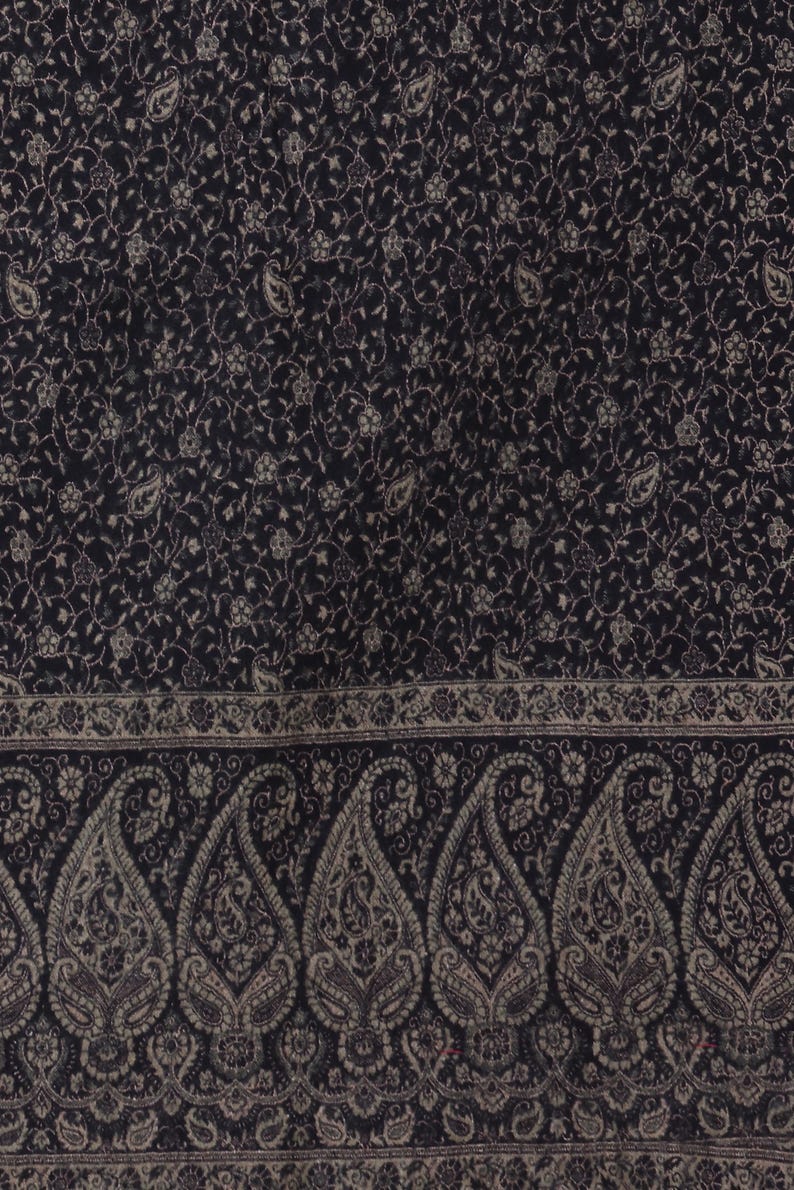 May include: Black shawl with a paisley pattern and a border of smaller paisley designs.