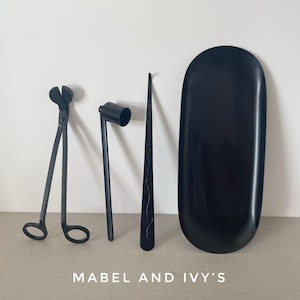 May include: A set of black candle care tools including a pair of wick trimmers, a wick dipper, a wick sticker, and a black tray.  Mabel and Ivy's.