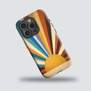 May include: A phone case featuring a retro sunset design. The case has a vibrant color palette of orange, yellow, brown, and blue radiating from a yellow sun. The case is designed to fit a smartphone and has camera cutouts.