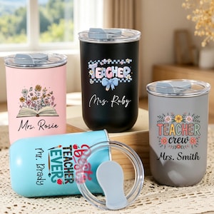 May include: Four cylindrical tumblers with clear lids, featuring personalized text and floral graphics. Colors include pink, black, light blue, and gray. Text includes "Mrs. Rosie," "Teacher Mrs. Ruby," "Best Teacher Ever Mr. Brady," and "Teacher crew Mrs. Smith."