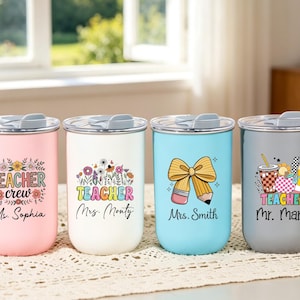 May include: Four stainless steel tumblers with lids in pink, white, light blue, and gray. Each features colorful teacher-themed graphics and names: Teacher crew Ms. Sophia, Teacher Mrs. Monty, Mrs. Smith with a pencil bow, and Teacher Mr. Mark.