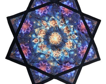 May include: A large, eight-pointed star-shaped tapestry with a mandala design in shades of blue, purple, and gold. The mandala features intricate details and a central golden sunburst.