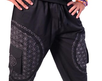 May include: Black pants with a geometric pattern on the legs. The pattern is a white flower of life design.