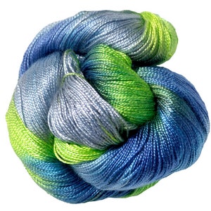 May include: A skein of blue, green and teal yarn with a gradient effect. The yarn is made of silk and is soft and smooth.