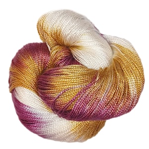 May include: A skein of yarn in shades of burgundy, gold, and white. The yarn is made of silk and has a subtle sheen.