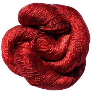 May include: A ball of deep crimson yarn, tightly wound. The yarn has a lustrous, smooth texture, catching the light and creating highlights. The colour is a rich, saturated shade, suggesting a luxurious fibre suitable for knitting or crochet projects.