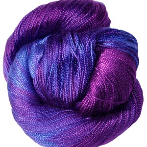 May include: A skein of purple and blue yarn with a gradient effect. The yarn is soft and silky, and it is perfect for knitting or crocheting.