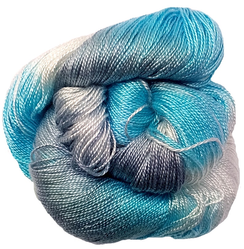 May include: A skein of yarn in shades of blue, gray, and white. The yarn is soft and silky, and it is perfect for knitting or crocheting.