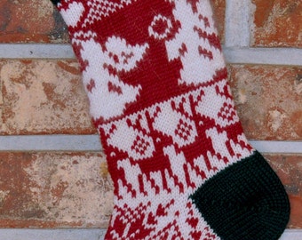 May include: A red and white knitted Christmas stocking with a green cuff and toe. The stocking features a snowflake pattern and a small, white pom-pom on top.