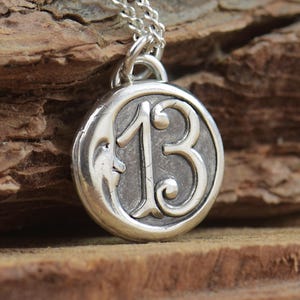 Colgante luna con número 13 en plata.Pieza artesanal.