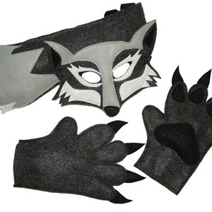 May include: A gray wolf costume set for kids includes a mask, a tail, and two paw gloves. The mask has white accents around the eyes and nose. The tail is attached to a strap that goes around the waist. The gloves have black claws.