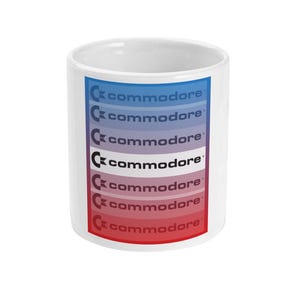 May include: White ceramic mug with a gradient design of blue, purple and red stripes. The word "commodore" is repeated in black text on each stripe.