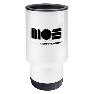 May include: White travel mug with a black lid and base. The mug features the logo "MOS" in black, with the text "The Sound of commodore" below it. The mug is cylindrical and designed for beverages.