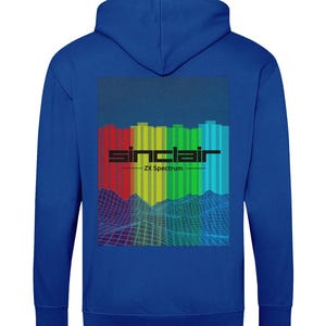 May include: A royal blue hoodie with a colorful graphic on the back. The graphic features a rainbow of vertical bars with the text "sinclair ZX Spectrum" in black.