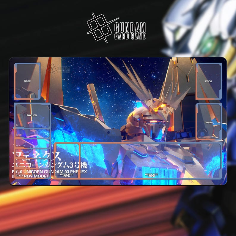 May include: A rectangular Gundam card game playmat featuring a detailed illustration of a mecha robot against a starry background. The mat has designated areas for cards, labeled "Deck," "Trash," "Shields," and "Discard." The Gundam Card Game logo is at the top.