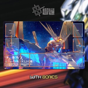 May include: A rectangular Gundam card game playmat featuring a detailed illustration of a mecha robot with a blue and orange color scheme. The mat includes designated zones for cards and the text "WITH ZONES". The Gundam Card Game logo is at the top.