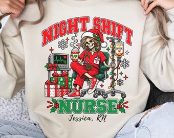 May include: A sand-colored crewneck sweatshirt featuring a graphic of a skeleton nurse in red scrubs and a Santa hat, sitting in a chair with a coffee cup, IV pole, and medical monitor. The text reads NIGHT SHIFT NURSE and Jessica, RN.