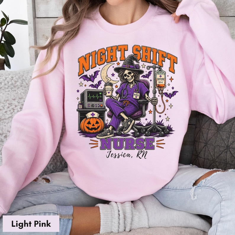 May include: A light pink sweatshirt featuring a graphic of a skeleton nurse in a purple scrub set and witch hat, sitting in a chair with a coffee cup and IV drip. The text reads NIGHT SHIFT NURSE and Jessica, RN, with a pumpkin and monitor.