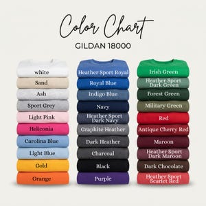 May include: A Gildan 18000 color chart displaying three vertical stacks of folded sweatshirts in various colors. The text Color Chart and GILDAN 18000 appear at the top. Each sweatshirt is labeled with its specific color name printed on the fabric.