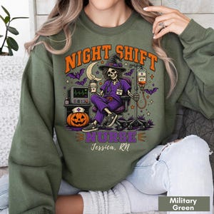 May include: An olive green crewneck sweatshirt featuring a graphic of a skeleton nurse in a purple uniform and witch hat, sitting in a chair with an IV drip, a pumpkin, and a heart monitor. The text reads NIGHT SHIFT NURSE and Jessica, RN.