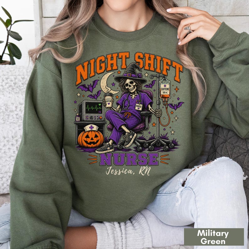 May include: An olive green crewneck sweatshirt featuring a graphic of a skeleton nurse in a purple uniform and witch hat, sitting in a chair with an IV drip, a pumpkin, and a heart monitor. The text reads NIGHT SHIFT NURSE and Jessica, RN.