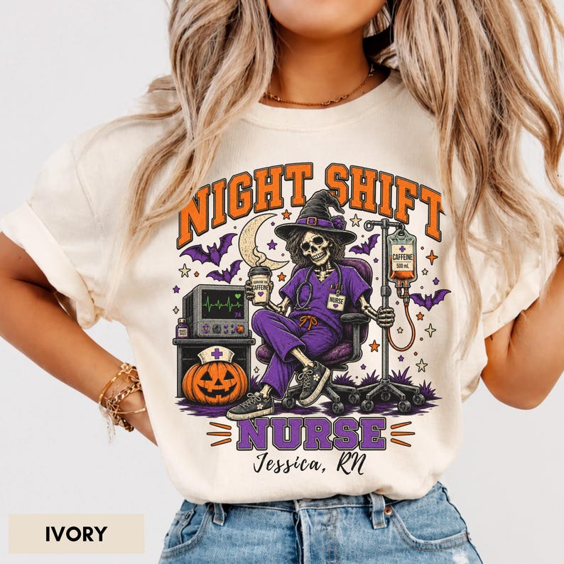 May include: An ivory t-shirt featuring a graphic of a skeleton nurse in a witch hat sitting in a chair, holding a coffee cup. The design includes a pumpkin with a nurse cap, an IV pole, bats, and the text NIGHT SHIFT NURSE Jessica, RN.