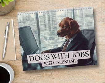 May include: A spiral-bound 2027 calendar titled DOGS WITH JOBS. The cover features an illustration of a brown dog wearing a suit and tie, sitting at a desk in front of a computer monitor in an office setting with large windows in the background.