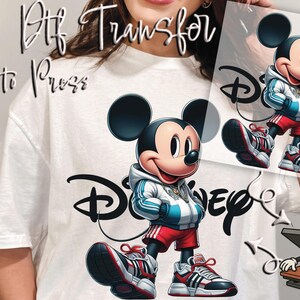 May include: DTF transfer featuring a cartoon Mickey Mouse in a stylish outfit, including a hoodie, shorts, and sneakers. The design incorporates the Disney logo. The words "DTF Transfer" and "Ready to Press" are also visible.