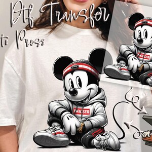 May include: DTF transfer featuring a cartoon Mickey Mouse in a streetwear style. Mickey is wearing a hoodie, sneakers, and a headband. The image includes the text "DTF Transfer Ready to Press".