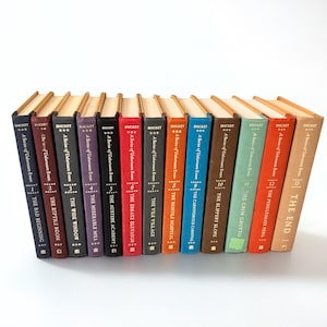 May include: A set of 13 hardcover books with gold lettering and spines. The books are titled "A Series of Unfortunate Events" and each book has a number and title. The titles are: "The Bad Beginning", "The Reptile Room", "The Wide Window", "The Miserable Mill", "The Austere Academy", "The Ersatz Elevator", "The Vile Village", "The Hostile Hospital", "The Carnivorous Carnival", "The Slippery Slope", "The Grim Grotto", "The Penultimate Peril", and "The End".