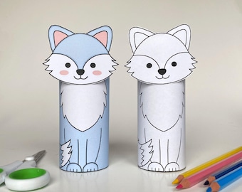 May include: Two paper craft wolf templates, one blue and one white, ready to be colored. The templates are printed on white paper and have black outlines. The wolves are standing on a white surface.