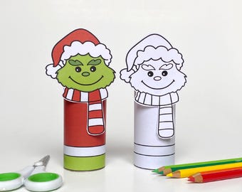 May include: Two paper tube Christmas ornaments, one colored green and red, the other white, both with a Grinch face and Santa hat. The ornaments are on a white surface with colored pencils.