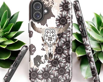 May include: A white phone case with a black and white cow skull and sunflowers. The case has a distressed look and is made of durable plastic.