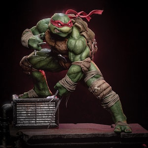 Pode incluir: Uma figura de ação da Tartaruga Ninja Adolescente Mutante verde com uma bandana vermelha e uma máscara vermelha. A figura está em posição de combate com os braços levantados e as pernas separadas. A figura está em pé sobre uma grelha de metal.